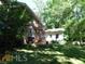 Brick home with a detached building and patio at 573 Lester Rd, Fayetteville, GA 30215