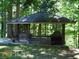 Screened gazebo with stone fireplace and deck at 573 Lester Rd, Fayetteville, GA 30215