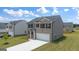 Two-story house with gray siding and a two-car garage at 536 Whitman (Lot 2010) Ln # 2010, Stockbridge, GA 30281