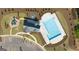 Aerial view of community pool, playground, and parking lot at 619 Whitman Ln # 2200, Stockbridge, GA 30281