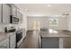 Modern kitchen with gray cabinets and granite island at 619 Whitman Ln # 2200, Stockbridge, GA 30281