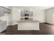 Modern kitchen with gray cabinets, granite countertops, and an island at 619 Whitman Ln # 2200, Stockbridge, GA 30281