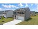 Two-story house with gray and beige siding, a two-car garage, and a landscaped yard at 619 Whitman Ln # 2200, Stockbridge, GA 30281