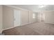 Well-lit bedroom with carpet flooring and door to hallway at 78 Candlelight Ln, Atlanta, GA 30331