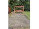 Red wooden swing set on a concrete pad at 2531 Quentin Dr, Jonesboro, GA 30236