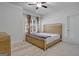 Main bedroom with a king-size bed, carpeted floor, and ceiling fan at 3290 Stock Saddle Pl, Cumming, GA 30040