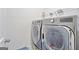 Laundry room with a washer and dryer, and overhead shelving at 3290 Stock Saddle Pl, Cumming, GA 30040