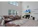 Spacious living room with a fireplace, large windows, and comfortable seating at 3290 Stock Saddle Pl, Cumming, GA 30040
