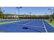 Blue tennis courts with surrounding fence at 3290 Stock Saddle Pl, Cumming, GA 30040