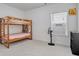 Well-lit bedroom with a bunk bed, carpet flooring, and a window with blinds at 3290 Stock Saddle Pl, Cumming, GA 30040