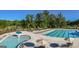 Community pool with multiple areas and lounge chairs at 3290 Stock Saddle Pl, Cumming, GA 30040