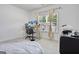 Bright bedroom with a standing desk, window with curtains, and carpeted floor at 3290 Stock Saddle Pl, Cumming, GA 30040