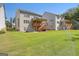 Large backyard with sprinkler system and two homes visible at 3290 Stock Saddle Pl, Cumming, GA 30040