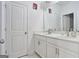 Double vanity bathroom with white cabinets and a large mirror at 3290 Stock Saddle Pl, Cumming, GA 30040