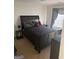 Large bedroom with a queen bed and nightstand at 6996 Talkeetna Sw Ct, Atlanta, GA 30331