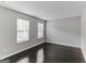 Bright bedroom with dark hardwood floors and two large windows at 1125 Misty Meadows Ln, Hampton, GA 30228