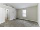 Bedroom with carpet, neutral walls, and access to hallway at 1125 Misty Meadows Ln, Hampton, GA 30228