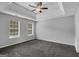 Spacious bedroom with carpet, neutral walls, and two windows at 1125 Misty Meadows Ln, Hampton, GA 30228