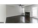 Living room with fireplace, dark hardwood floors, and sliding glass doors at 1125 Misty Meadows Ln, Hampton, GA 30228