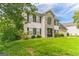 Two-story house with stone accents, double garage, and landscaped lawn at 1125 Misty Meadows Ln, Hampton, GA 30228