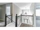 Upper level landing with staircase, carpeting, and access to bedrooms at 1125 Misty Meadows Ln, Hampton, GA 30228