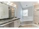 Bathroom with corner bathtub, shower, and granite vanity at 1125 Misty Meadows Ln, Hampton, GA 30228