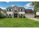 Two-story house with stone accents, double garage, and landscaped lawn at 1125 Misty Meadows Ln, Hampton, GA 30228