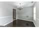 Bright dining room with dark hardwood floors and chandelier at 1125 Misty Meadows Ln, Hampton, GA 30228