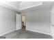 Bedroom with carpet, neutral walls, and access to hallway at 1125 Misty Meadows Ln, Hampton, GA 30228