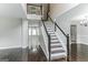 Elegant staircase with dark wood and white railings at 1125 Misty Meadows Ln, Hampton, GA 30228