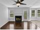 Living room with fireplace, hardwood floors, and access to backyard at 1125 Misty Meadows Ln, Hampton, GA 30228