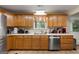 Kitchen features wood cabinets, stainless steel appliances, and a double sink at 3110 Highway 20 W, Hampton, GA 30228
