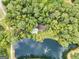 Aerial view of house on a wooded lot with a pond at 3110 Highway 20 W, Hampton, GA 30228