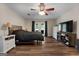 Main bedroom with ceiling fan, wood flooring, and patio access at 3110 Highway 20 W, Hampton, GA 30228