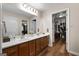 Bathroom with double vanity, large mirror, and walk-in closet at 3110 Highway 20 W, Hampton, GA 30228