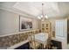 Elegant dining room with a chandelier and seating for eight at 710 Stonehenge Pl, Jonesboro, GA 30236