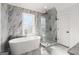 Modern bathroom with freestanding tub, glass shower, and marble tile at 3195 Camp Branch Rd, Buford, GA 30519