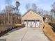 Three-car garage with brick exterior and carriage-style doors at 3195 Camp Branch Rd, Buford, GA 30519