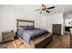 Spacious bedroom with hardwood floors, ceiling fan, and plush carpeting at 3195 Camp Branch Rd, Buford, GA 30519