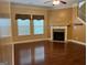 Spacious living room with hardwood floors and a gas fireplace at 1218 Heartwood Ave, Mcdonough, GA 30253