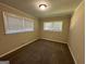 Bright bedroom with neutral walls, carpet flooring, and two windows with blinds at 3207 Cloverhurst Dr, East Point, GA 30344