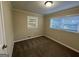 Well-lit bedroom featuring neutral walls, carpet flooring, and two windows with blinds at 3207 Cloverhurst Dr, East Point, GA 30344