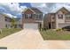 Two-story brick home with a two-car garage and landscaped lawn at 1705 Labonte Pkwy, Mcdonough, GA 30253
