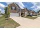 Townhouse-style home with attached garage and manicured lawn at 1705 Labonte Pkwy, Mcdonough, GA 30253