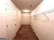 Spacious walk-in closet with double hanging rods and carpeting at 700 Emporia Loop, Mcdonough, GA 30253
