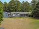 Gray house with large yard and wooded area, seen from above at 1142 Harbins Rd, Dacula, GA 30019