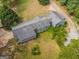 Aerial view of a long gray house with a large yard at 1142 Harbins Rd, Dacula, GA 30019