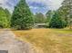 Ranch house with covered porch and spacious yard at 1142 Harbins Rd, Dacula, GA 30019