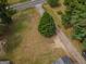 Aerial view of a large lot with a single tree in the center at 1142 Harbins Rd, Dacula, GA 30019