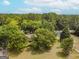 Aerial view of house nestled among trees at 1142 Harbins Rd, Dacula, GA 30019